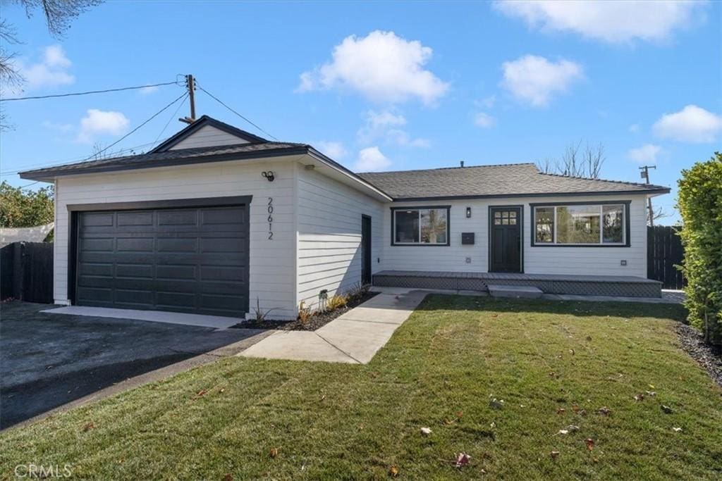 ranch-style home with a garage and a front yard