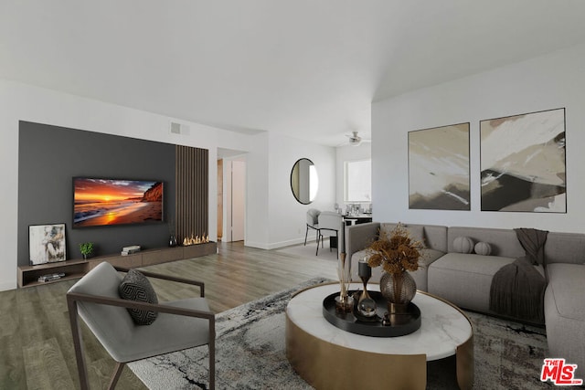 living room with ceiling fan and hardwood / wood-style floors