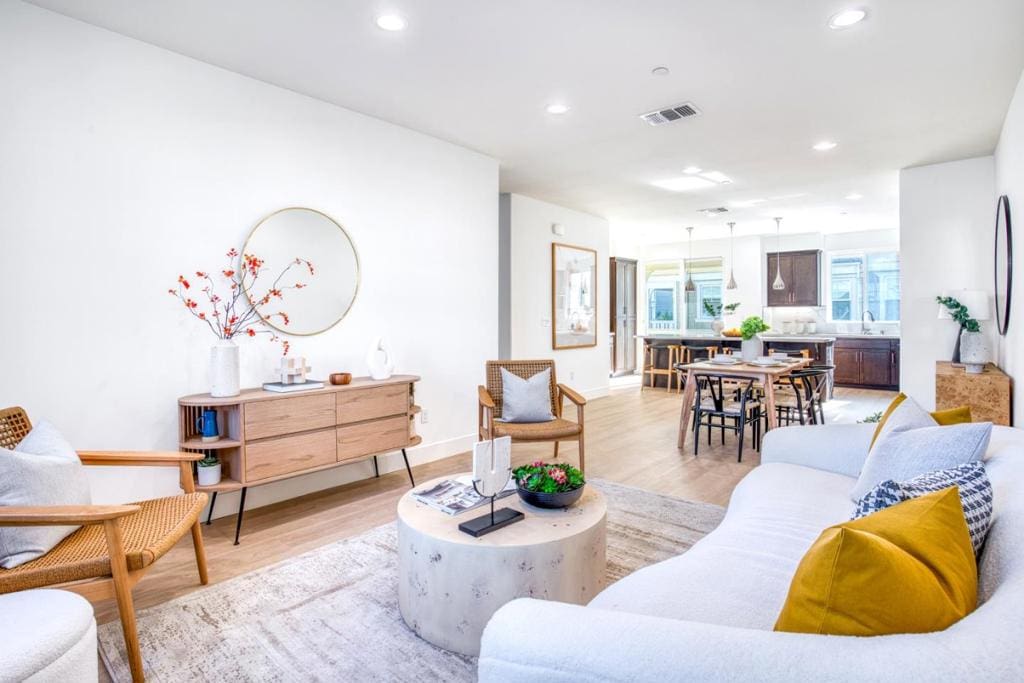 living room featuring sink and light hardwood / wood-style floors