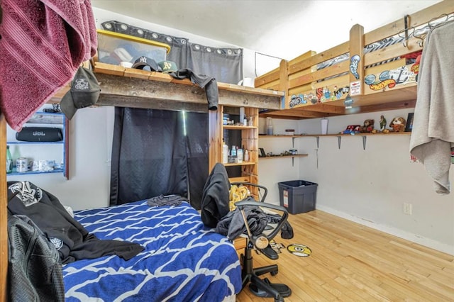 bedroom with hardwood / wood-style flooring