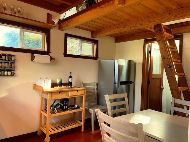 kitchen with beamed ceiling, wooden ceiling, dark hardwood / wood-style floors, and stainless steel fridge