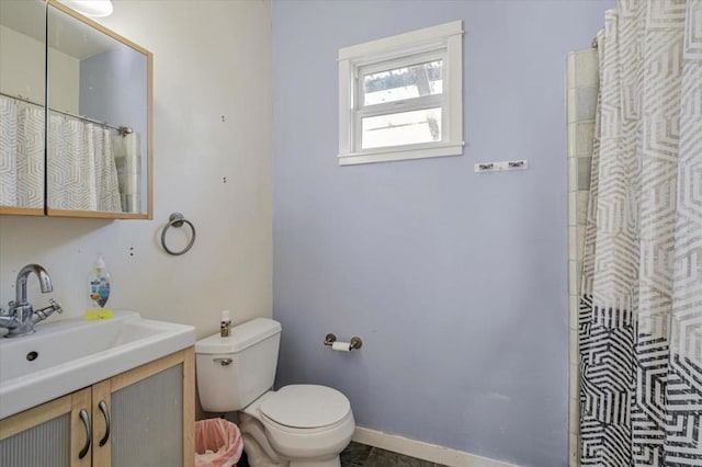 bathroom with vanity, curtained shower, and toilet