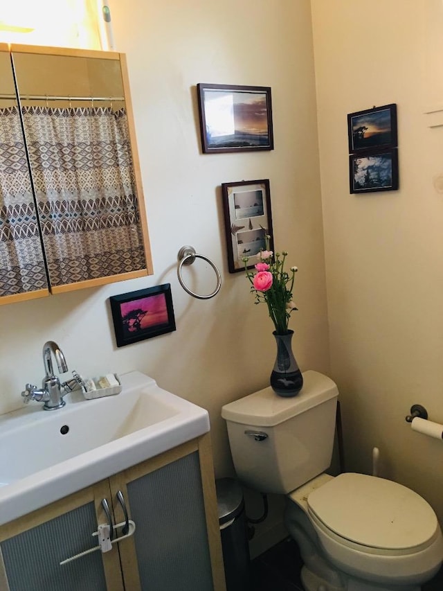 bathroom featuring vanity and toilet