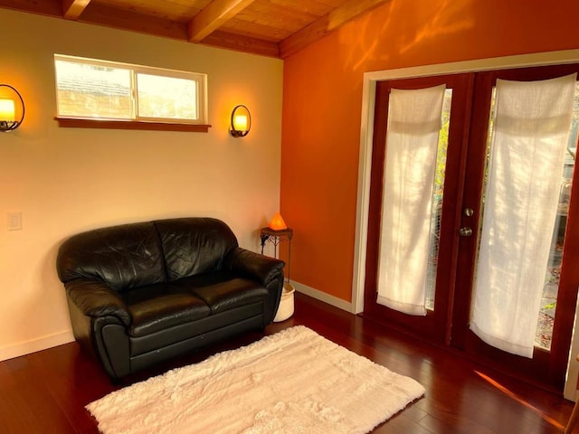 living area featuring french doors, beam ceiling, dark wood-type flooring, and wooden ceiling