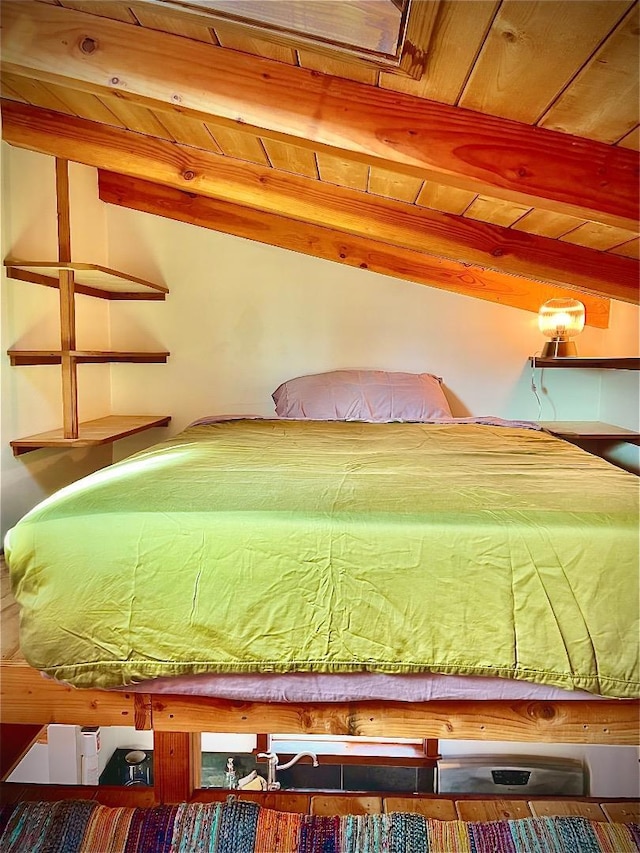 unfurnished bedroom featuring beamed ceiling and wood ceiling