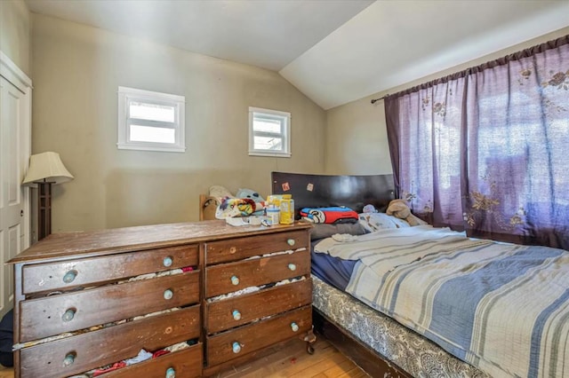 bedroom with hardwood / wood-style floors and vaulted ceiling