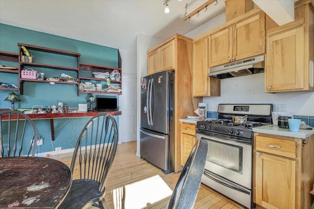 kitchen with light brown cabinetry, track lighting, light hardwood / wood-style floors, and appliances with stainless steel finishes