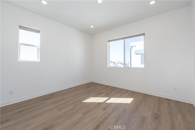 empty room with hardwood / wood-style flooring