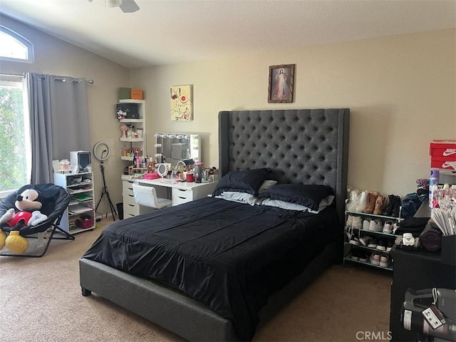 carpeted bedroom featuring vaulted ceiling and ceiling fan