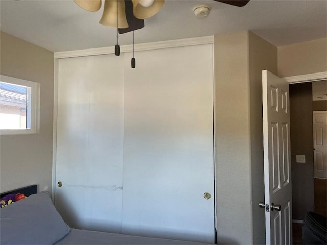 bedroom featuring ceiling fan and a closet