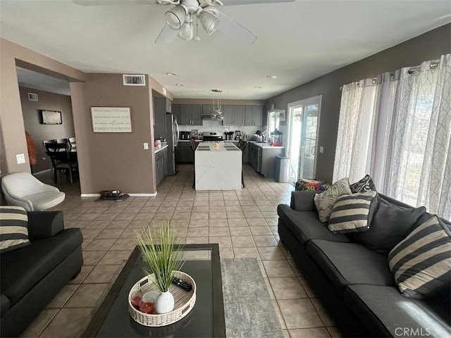 tiled living room with ceiling fan