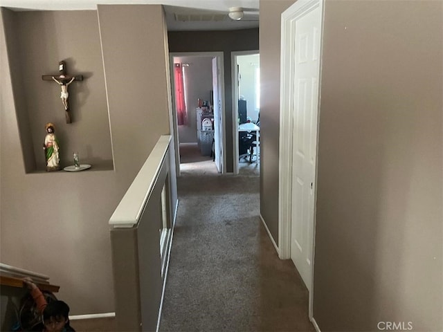 corridor with dark colored carpet