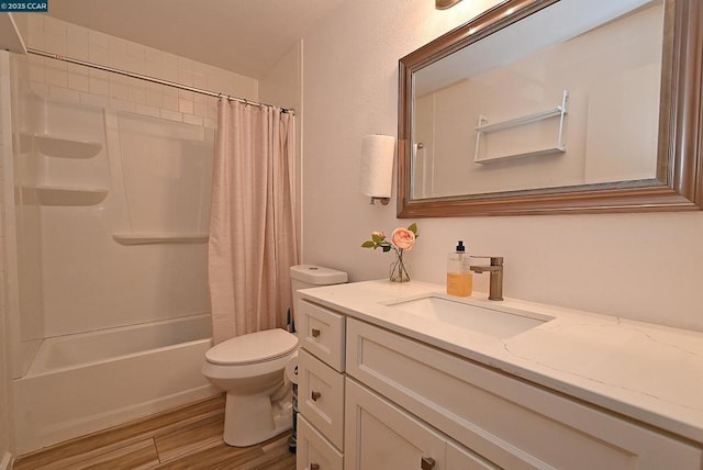 full bathroom with hardwood / wood-style flooring, vanity, shower / tub combo, and toilet