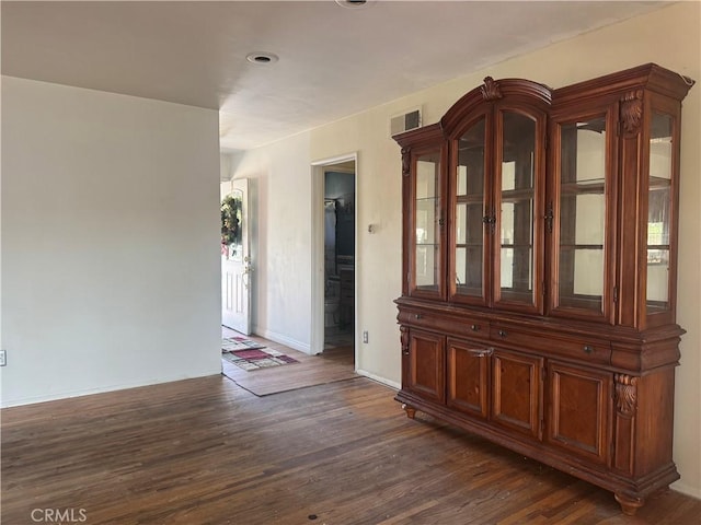 unfurnished room with dark hardwood / wood-style floors