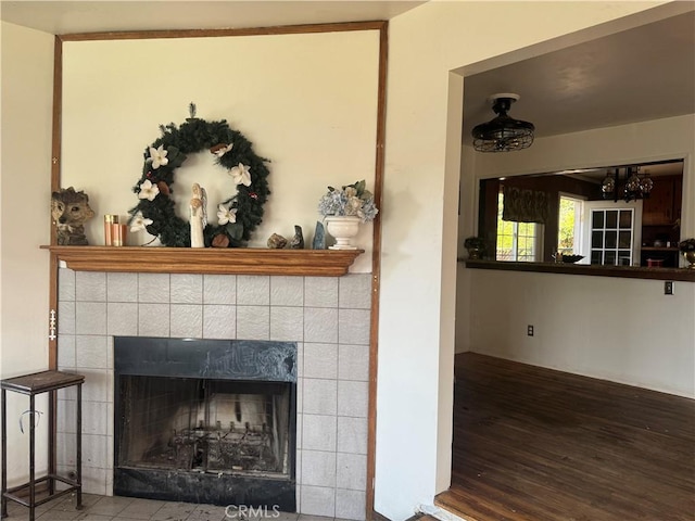 details featuring hardwood / wood-style flooring and a tile fireplace