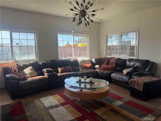 living room with dark wood-type flooring and a notable chandelier