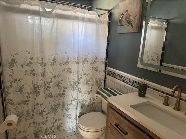 bathroom featuring vanity, tile walls, tile patterned floors, and toilet