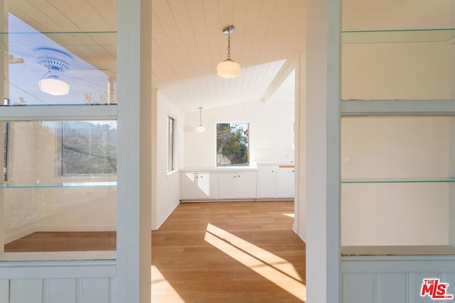 hallway featuring light hardwood / wood-style floors, wooden ceiling, and lofted ceiling