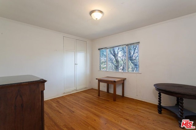 interior space with wood-type flooring and ornamental molding