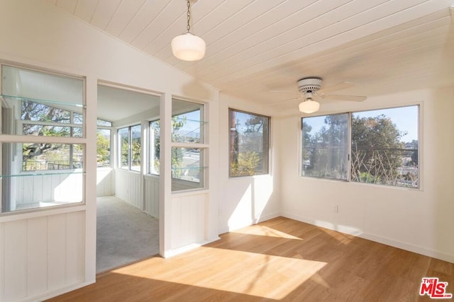 unfurnished sunroom with vaulted ceiling, ceiling fan, and wood ceiling