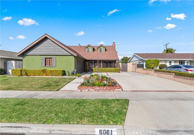 view of front of home featuring a garage and a front yard