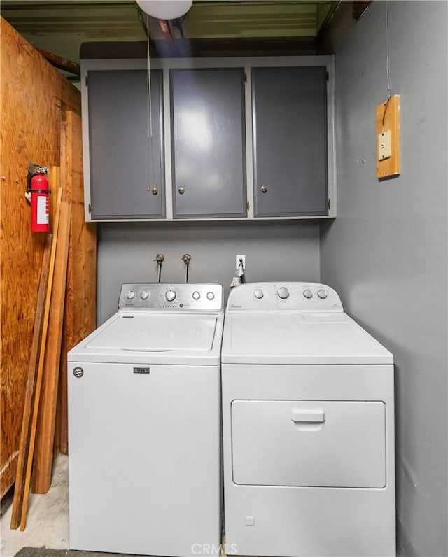 laundry room with cabinets and washing machine and dryer