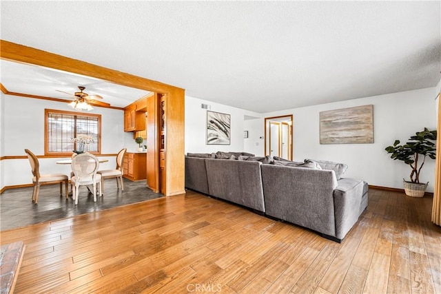 living room featuring ceiling fan and light hardwood / wood-style floors