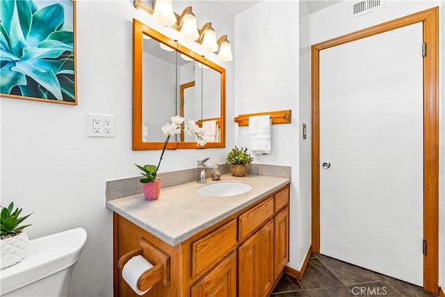 bathroom with tile patterned floors, vanity, and toilet