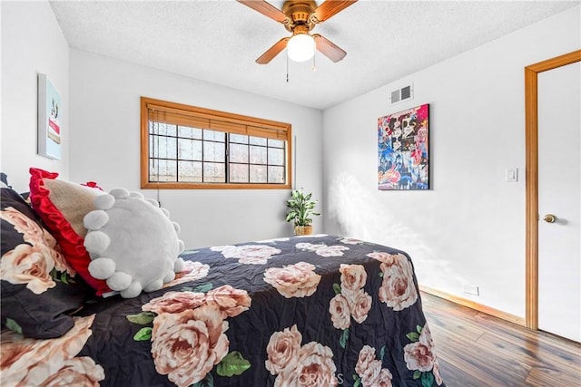 unfurnished bedroom with ceiling fan, hardwood / wood-style floors, and a textured ceiling