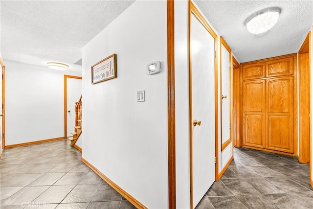 hallway featuring a textured ceiling