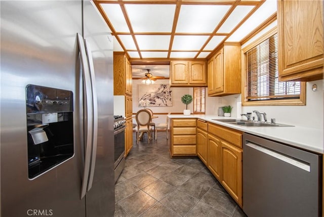 kitchen featuring stainless steel appliances, sink, and ceiling fan