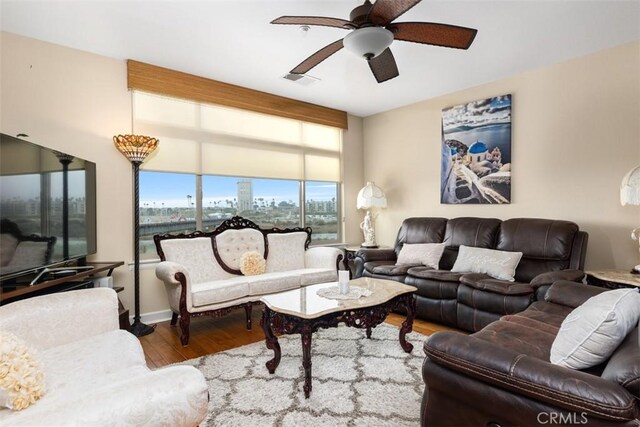 living room with wood-type flooring and ceiling fan