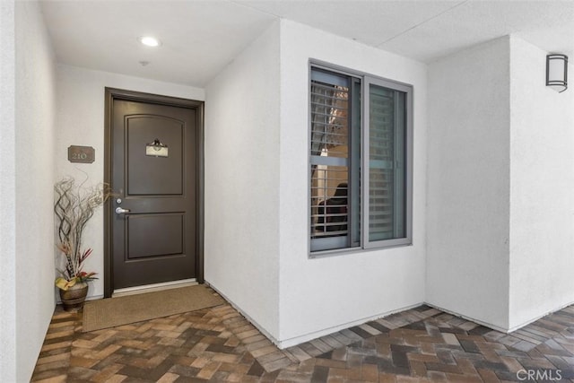 view of exterior entry with stucco siding