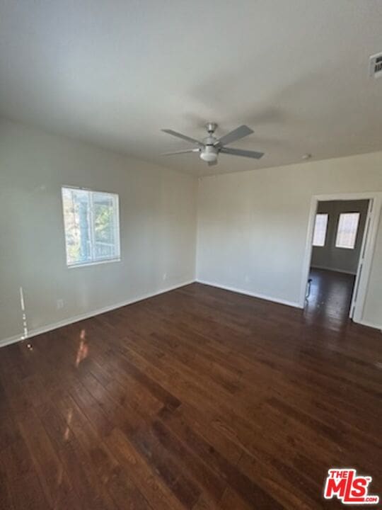 unfurnished room featuring ceiling fan and dark hardwood / wood-style floors