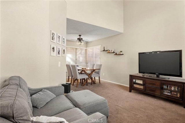 carpeted living room with ceiling fan