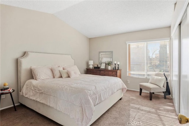 carpeted bedroom with lofted ceiling