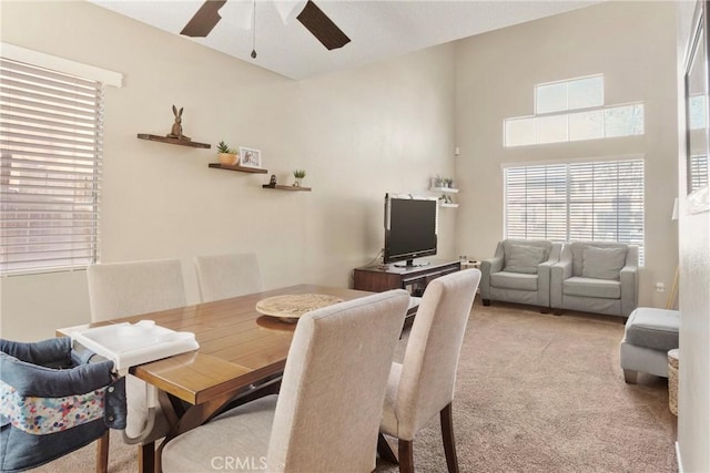 carpeted dining area featuring ceiling fan