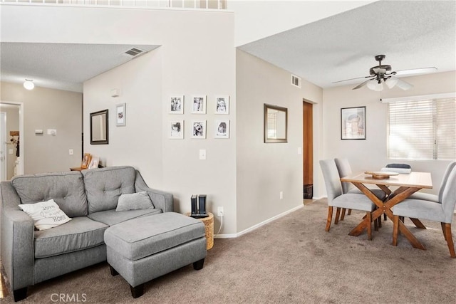 living room featuring ceiling fan and light colored carpet