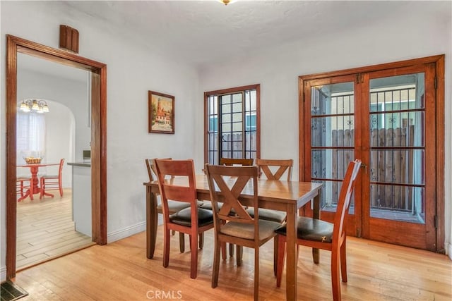 dining area featuring plenty of natural light and light hardwood / wood-style flooring