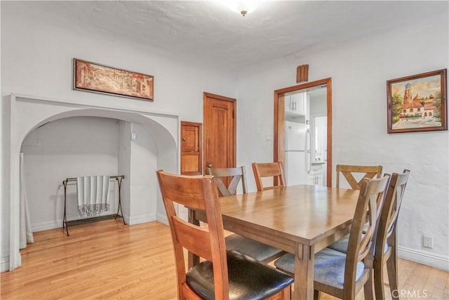 dining space with light hardwood / wood-style floors