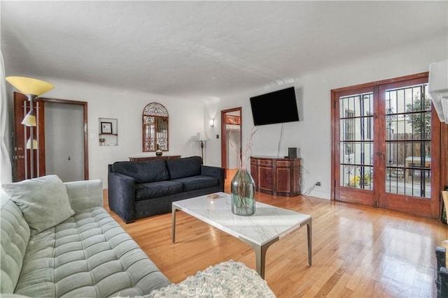 living room featuring light wood-type flooring and french doors