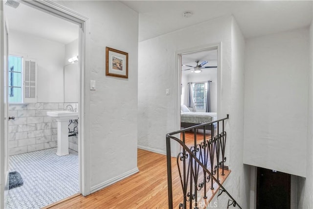 hallway featuring hardwood / wood-style flooring and sink