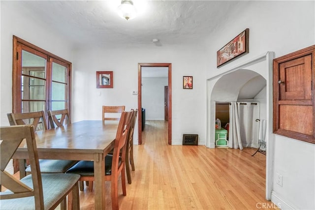 dining space with light hardwood / wood-style floors