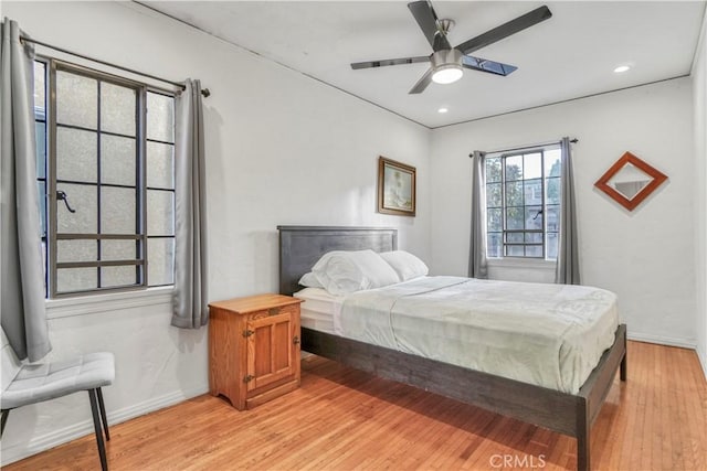 bedroom with ceiling fan and light wood-type flooring