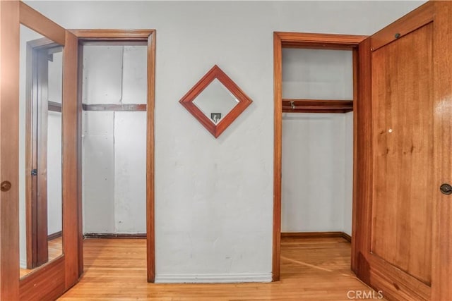 unfurnished bedroom with a closet and light hardwood / wood-style floors