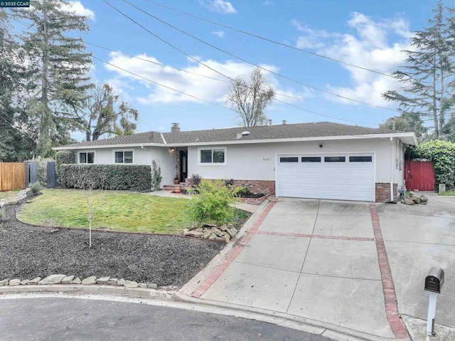 ranch-style home featuring a garage and a front lawn