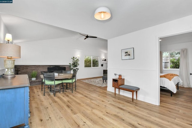 dining space with vaulted ceiling and light hardwood / wood-style floors