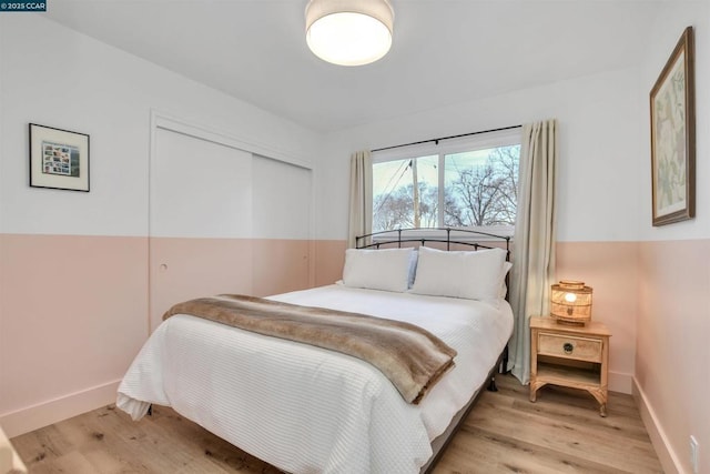 bedroom featuring light hardwood / wood-style floors and a closet