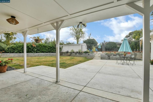 view of patio featuring a storage unit