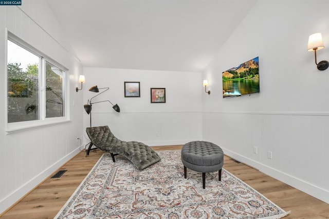 sitting room featuring lofted ceiling and wood-type flooring